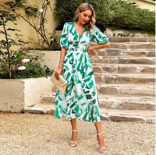 Summer V-Neck Printed Maxi Dress worn by a woman on a stone pathway surrounded by greenery.